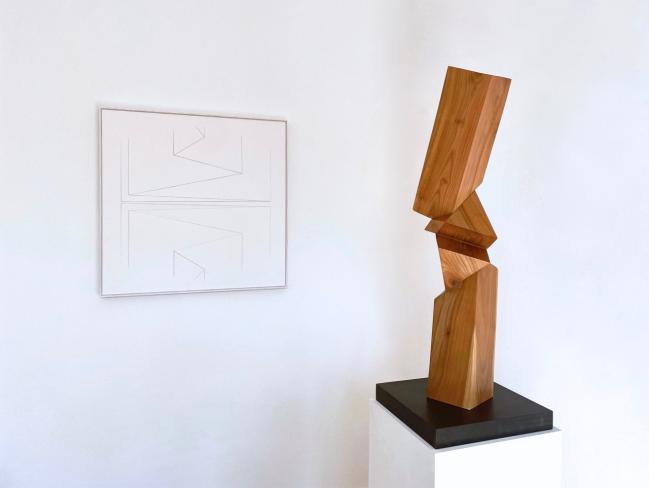 Robert Krainhöfner, Stele, 3-fach gefaltet, Kirschholz, Höhe 81 cm, Ausstellungsansicht mit einem Papierrelief von Franz Riedl 